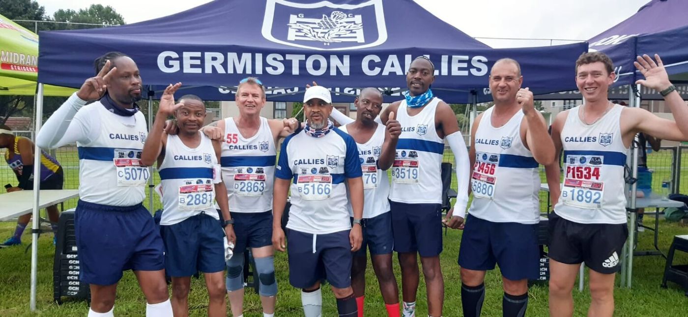 Callies runners in club vests celebrating at the club gazebo