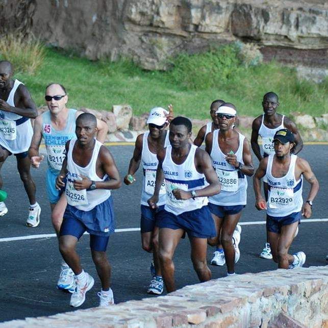 A pack of Germiston Callies runners in club vests on the Two Oceans Marathon route