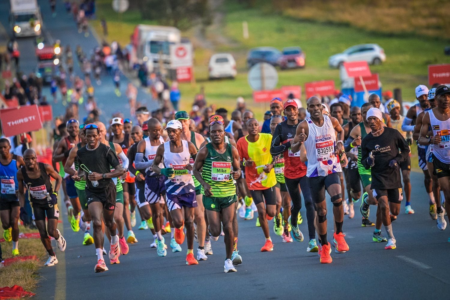 Runners climbing a hill early in the Comrades Marathon